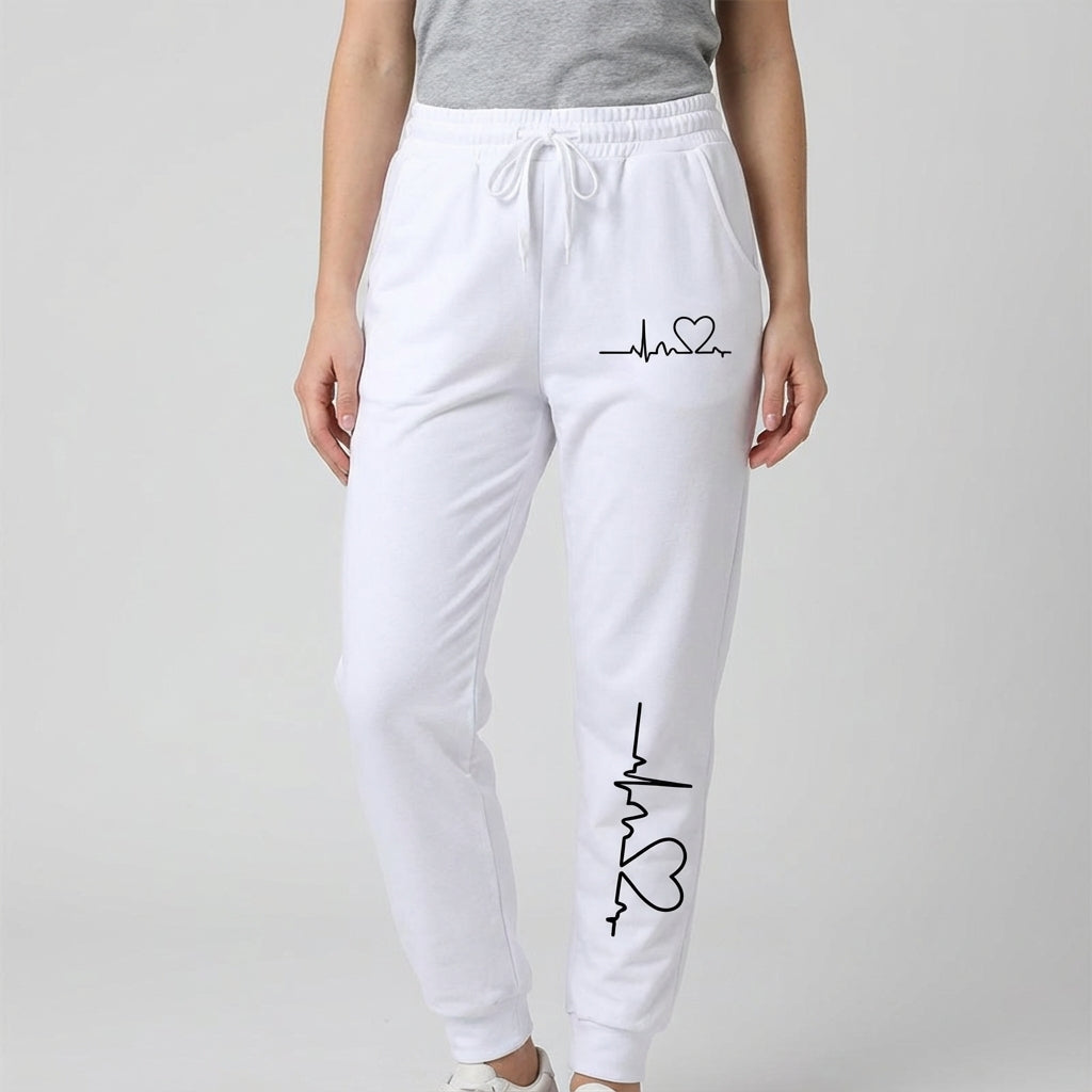Soft pink cotton women's trousers featuring a delicate heart motif, suitable for sports or relaxing
