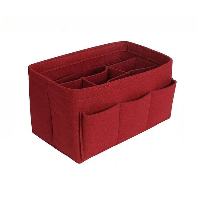 Close-up of beige felt purse insert showing various compartments for organized storage