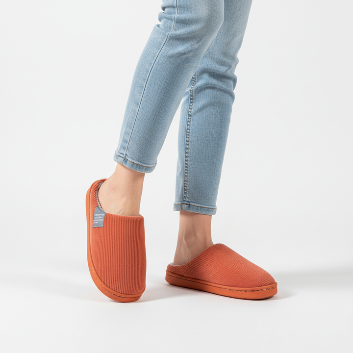 Indoor women's non-slip ribbed slippers with a warm lining, offering comfort and stability.