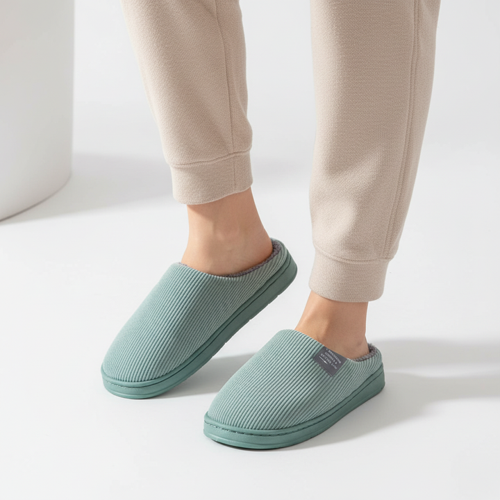 Plush women's non-slip house shoes featuring ribbed design, offering ultimate coziness and grip.