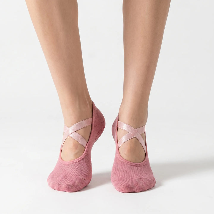 Pink women's athletic non-slip grip socks for studio workouts. Perfect for yoga, pilates, and barre sessions.