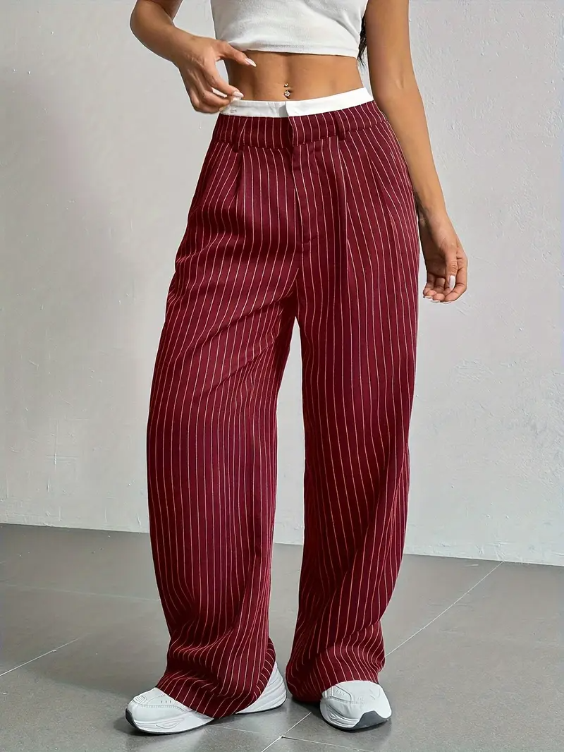 Model wearing women's pinstripe wide-leg trousers, highlighting their flowing silhouette.