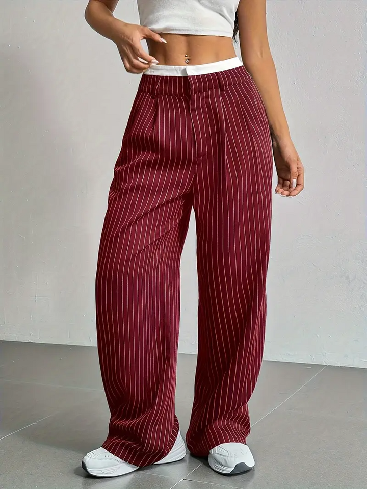Model wearing women's pinstripe wide-leg trousers, highlighting their flowing silhouette.