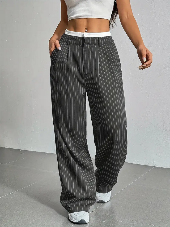 Flowing women's pinstripe wide-leg trousers, designed for freedom of movement and stylish comfort.