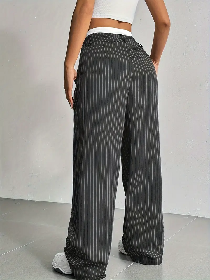 Close-up of the subtle pinstripe detail on women's wide-leg trousers, showcasing quality.