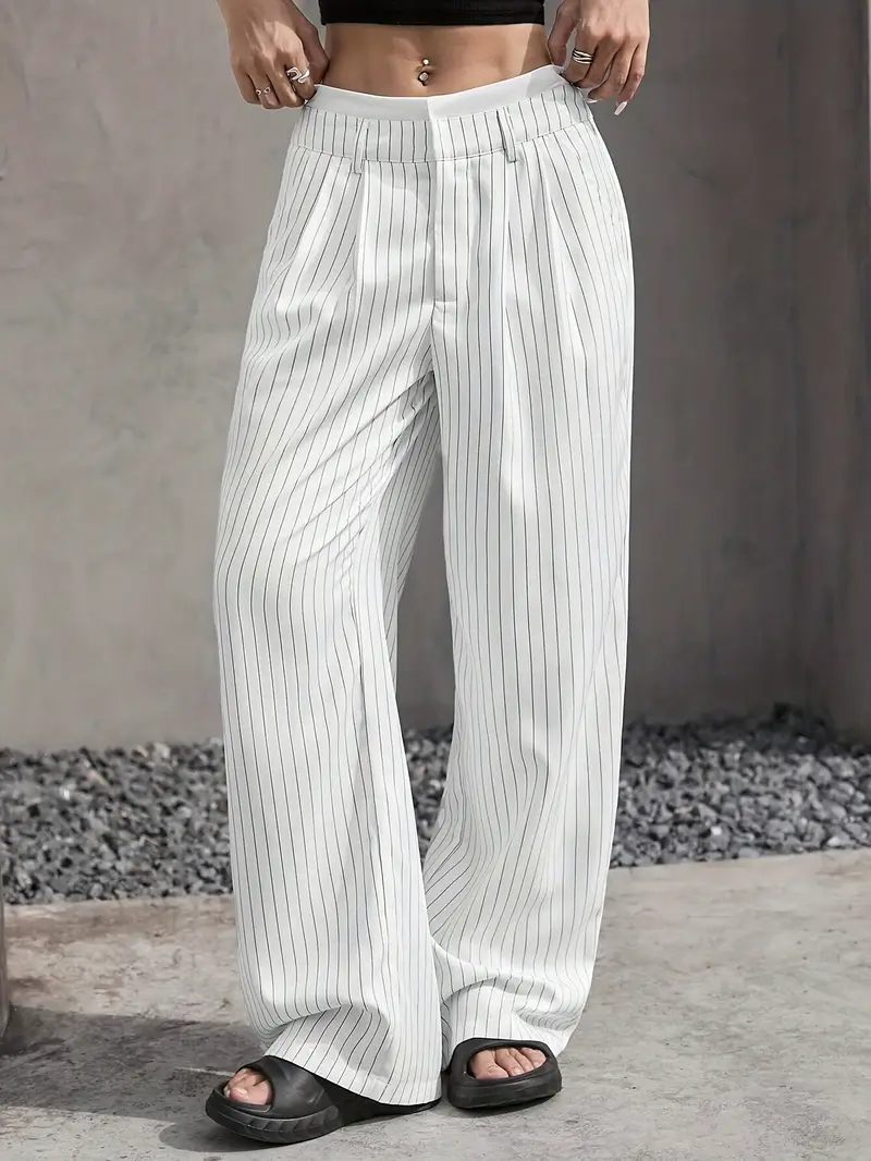 Women's pinstripe wide-leg trousers styled for a chic, comfortable look, highlighting versatility.