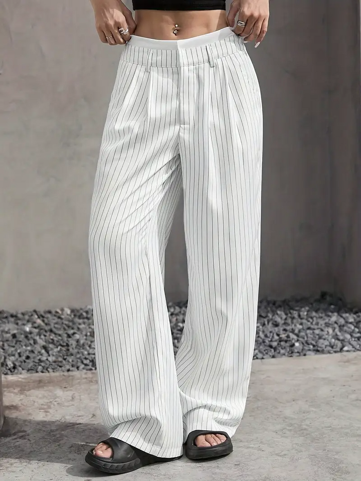 Women's pinstripe wide-leg trousers styled for a chic, comfortable look, highlighting versatility.