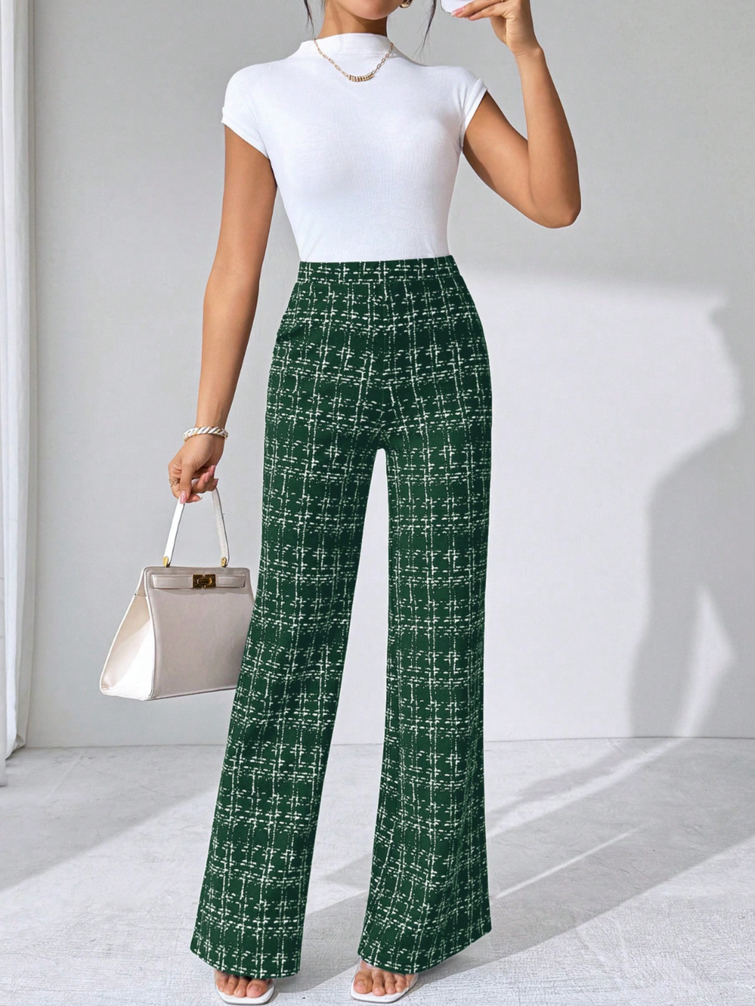Women's comfortable plaid high-waisted flare pants, knit fabric with elegant styling.