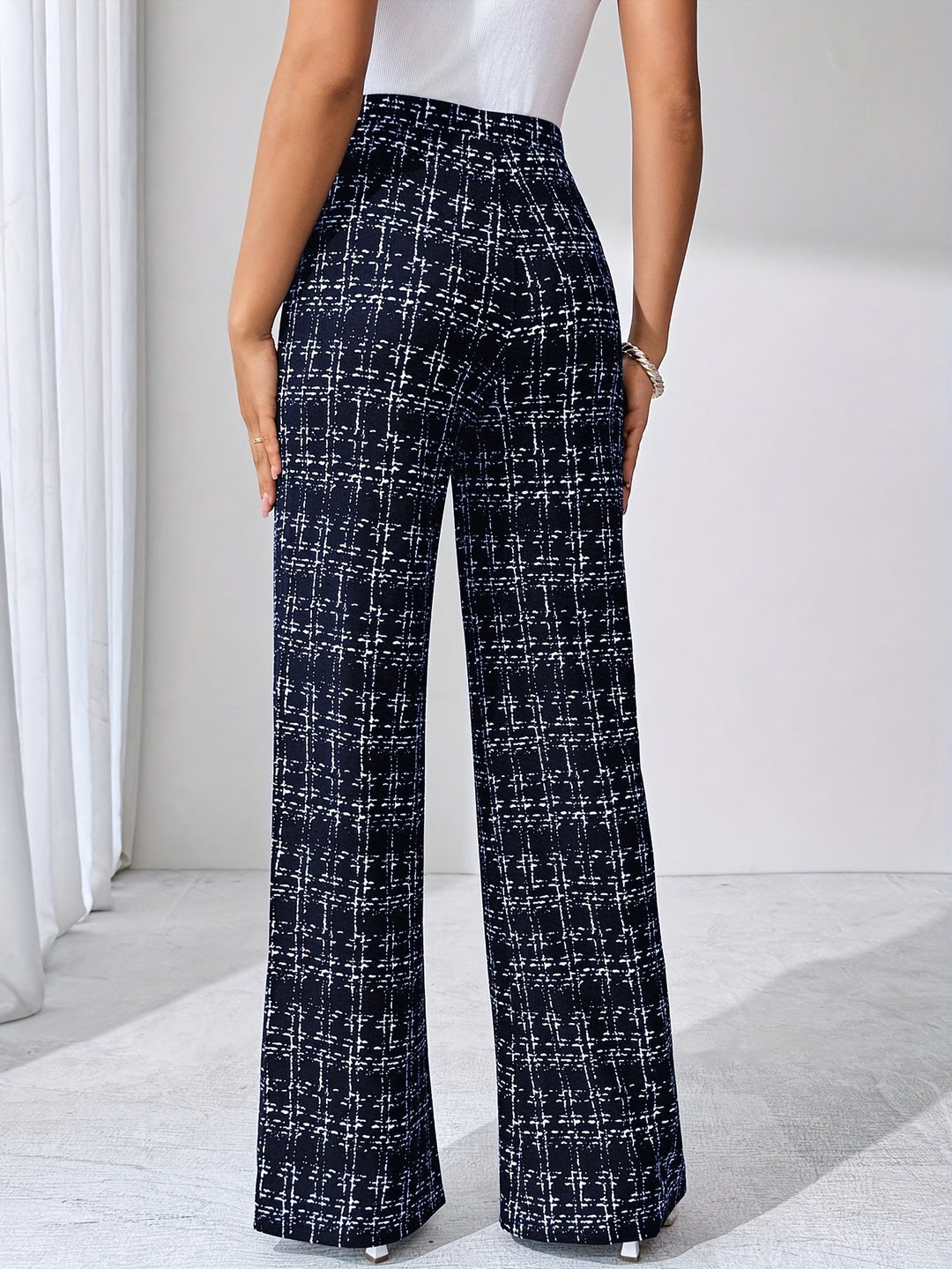 Women's high-waisted plaid flare pants, made from comfortable, stretchy knit fabric.
