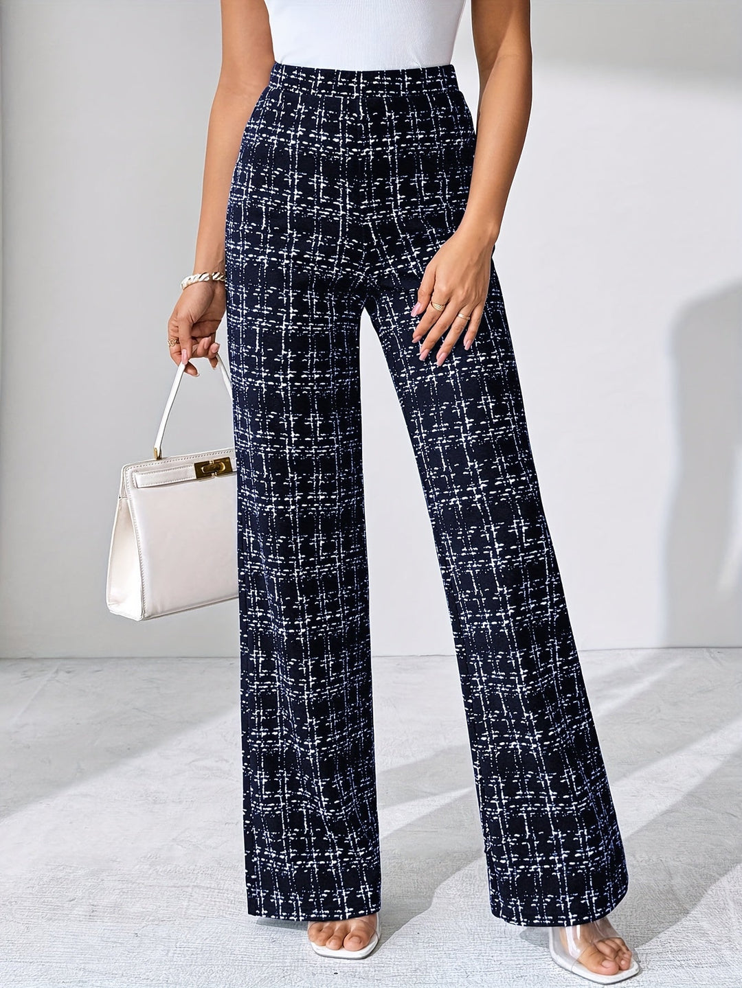 Modern women's plaid high-waisted flare pants, elegant and soft stretch knit.