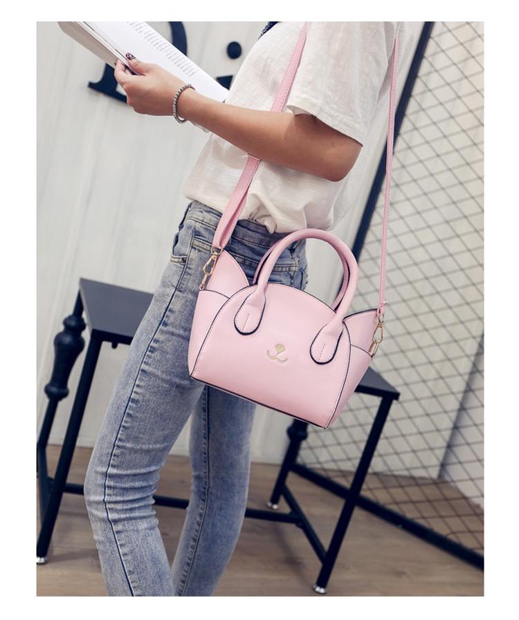 Chic black women's handbag with a playful cat accent, a faux leather shoulder bag for any occasion.