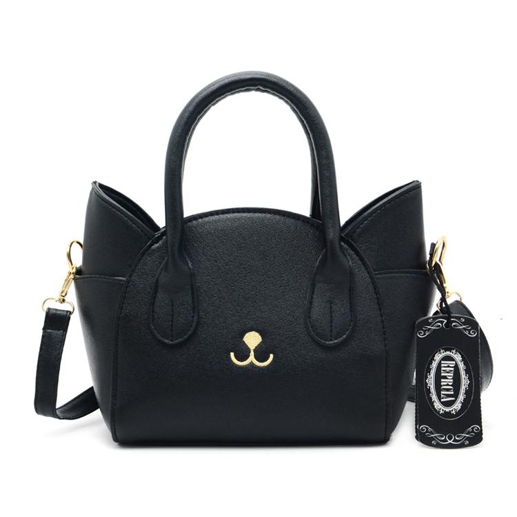 Women's playful cat accent shoulder bag, a durable faux leather crossbody purse for everyday fashion.