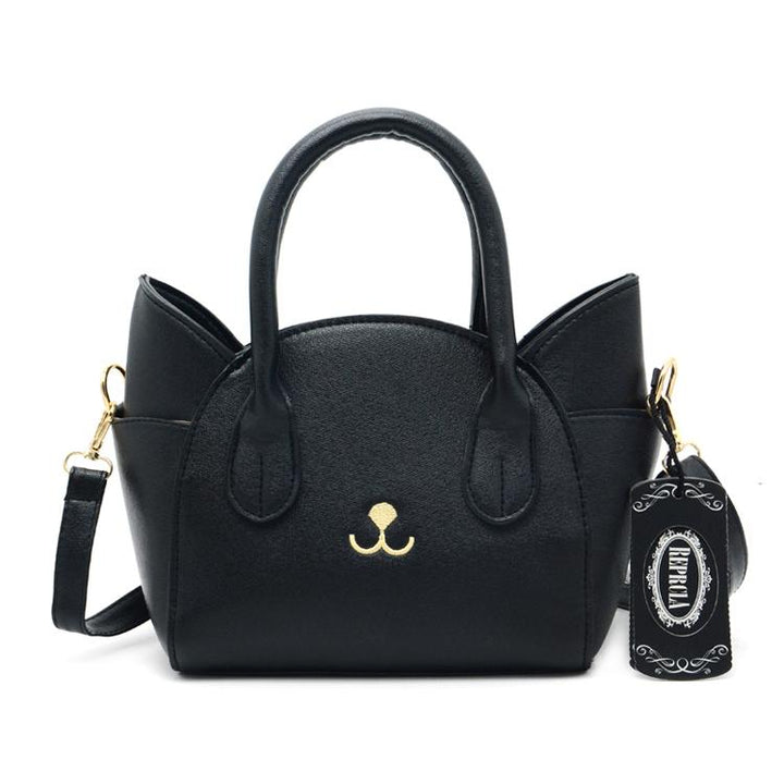 Women's playful cat accent shoulder bag, a durable faux leather crossbody purse for everyday fashion.