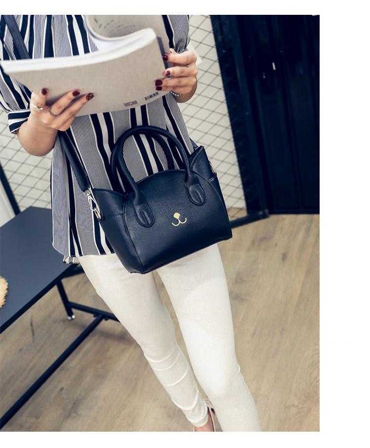 Faux leather women's handbag, a versatile shoulder & crossbody cat bag with a playful accent.