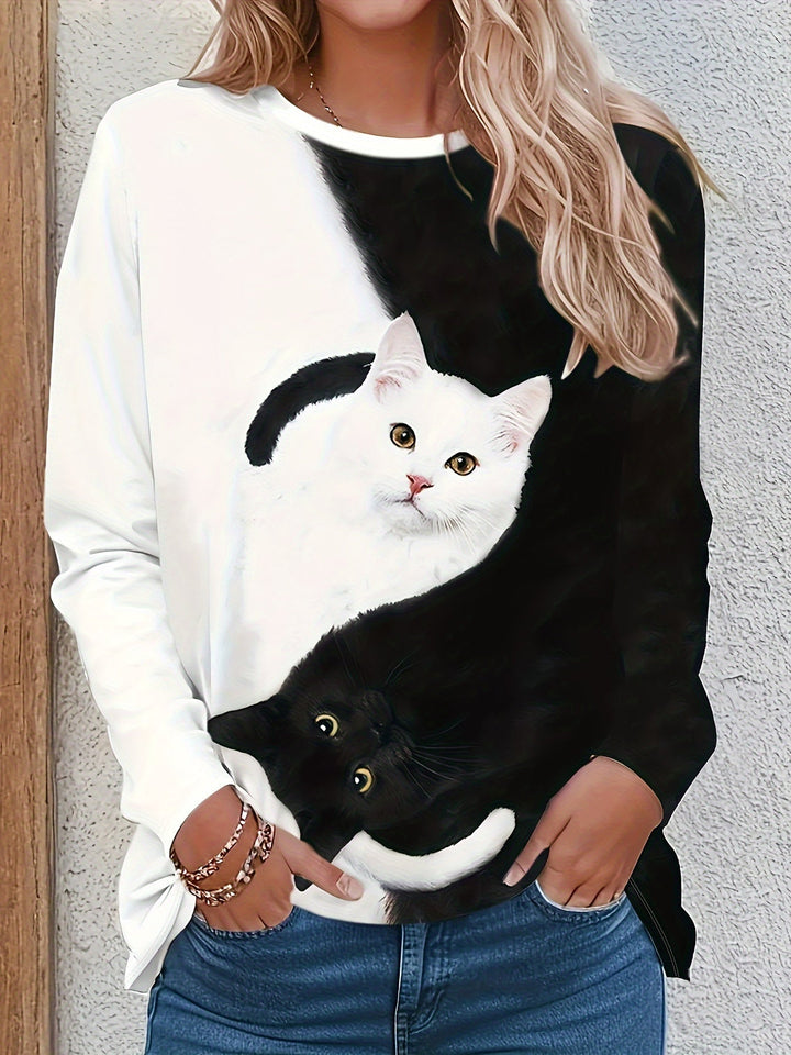 Women's playful long-sleeve t-shirt with a cute cat print and trendy color blocks, perfect for casual spring fashion.
