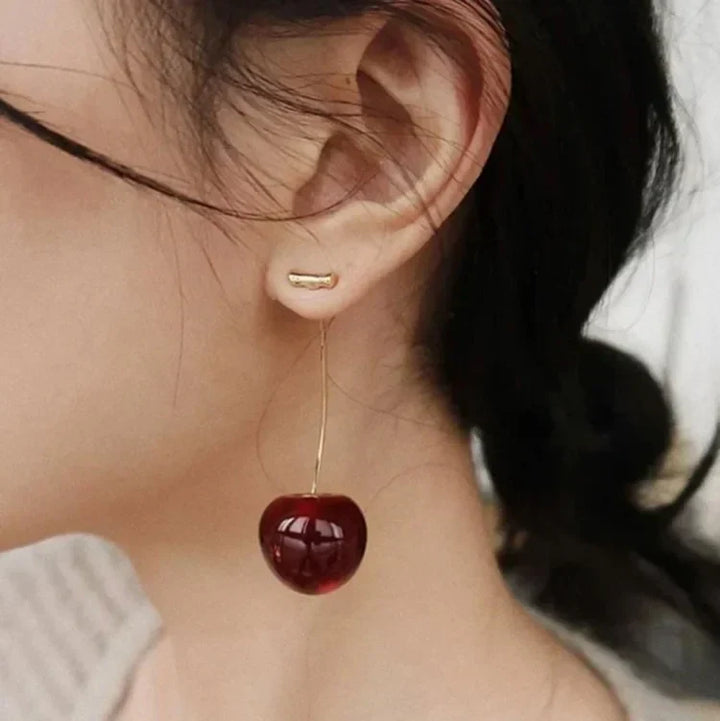 Women's playful red cherry drop earrings with gold plating, perfect for a fun fashion statement.