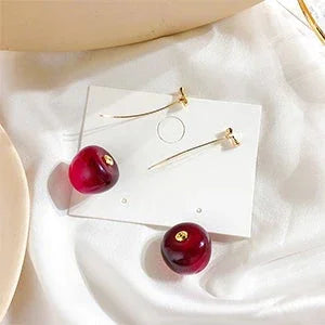 Hypoallergenic women's red cherry drop earrings, gold plated, a playful and unique fashion accessory.