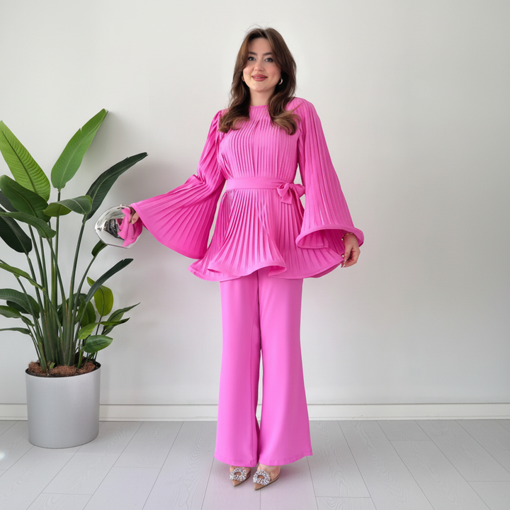 Model wearing a stylish women's pleated two-piece lounge set, perfect for casual wear.