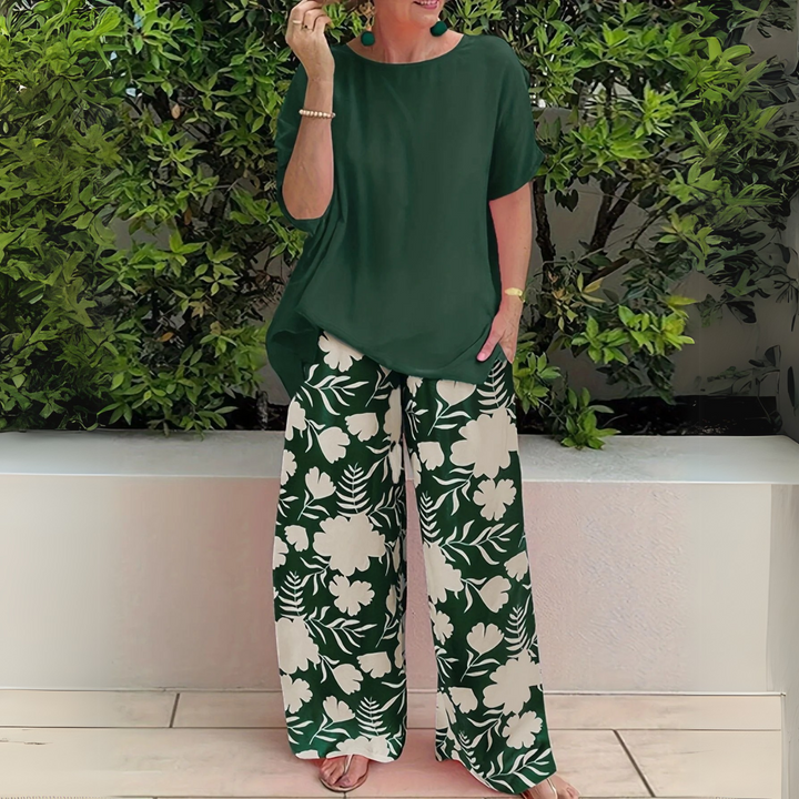 Women's plus size elegant two-piece set with vibrant floral print top and comfortable wide-leg pants.