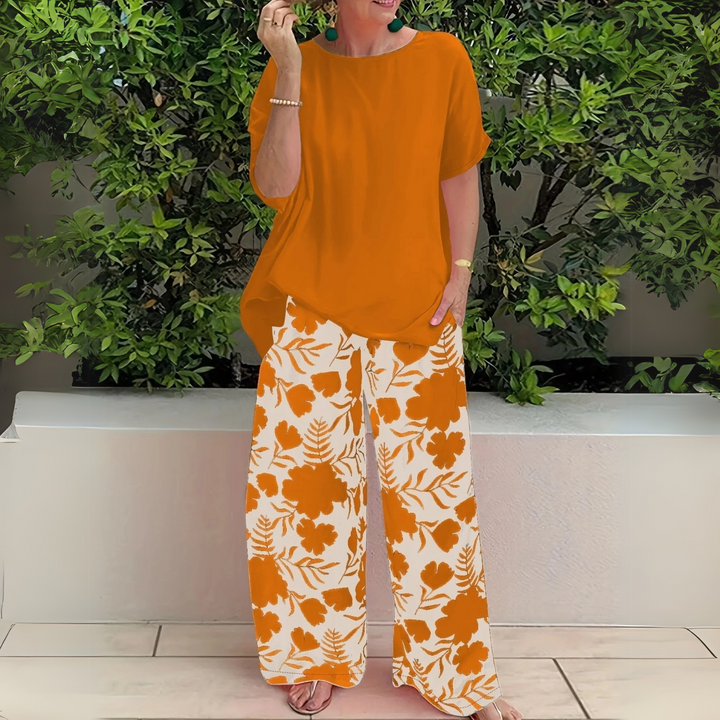 Versatile women's plus size elegant two-piece outfit, a comfortable floral print top with coordinating wide-leg trousers.