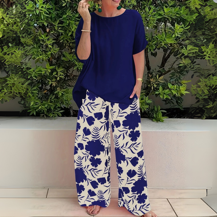 Chic women's plus size two-piece set for summer, an elegant floral top paired with comfortable wide-leg pants.