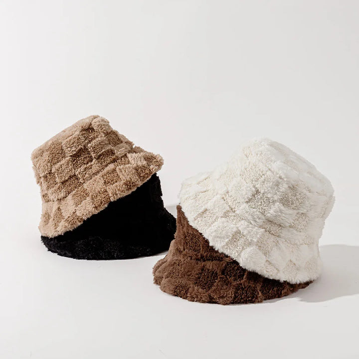 Women's luxurious plush checkerboard bucket hat, providing warmth & trendy style for winter.
