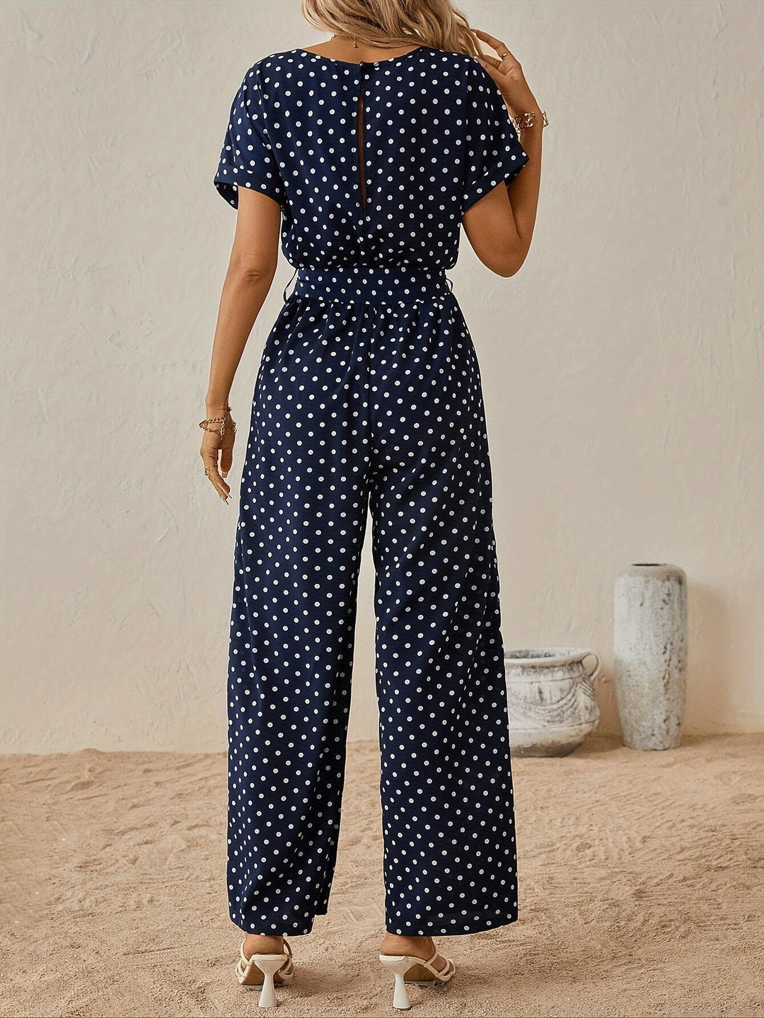 Casual short-sleeve polka dot jumpsuit for women, featuring an elastic waist for summer comfort.
