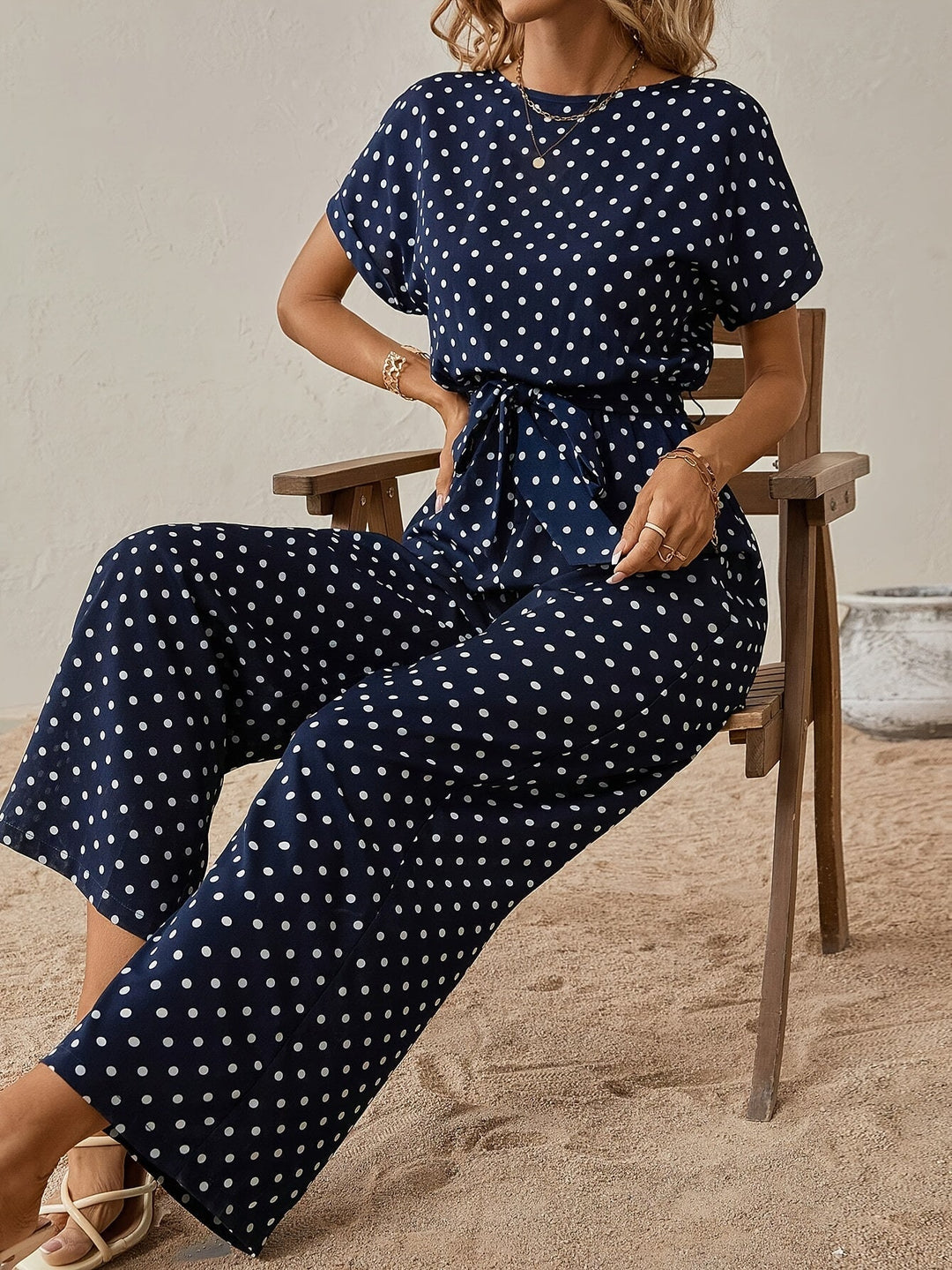 Stylish women's polka dot jumpsuit, ankle-length with an elastic waist, suitable for everyday wear.