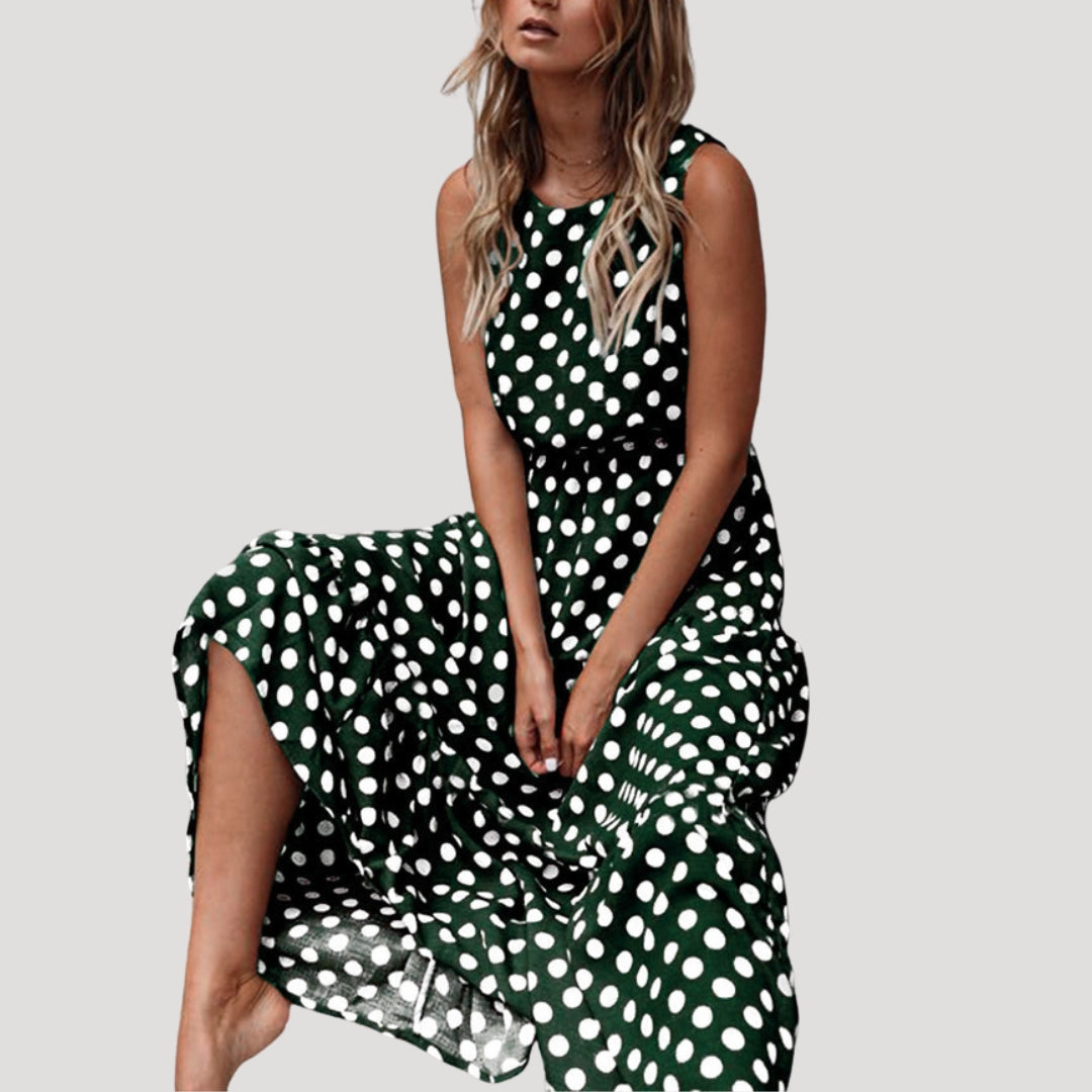 Flowy women's polka dot A-line midi dress, sleeveless design for a comfortable, elegant summer vacation.
