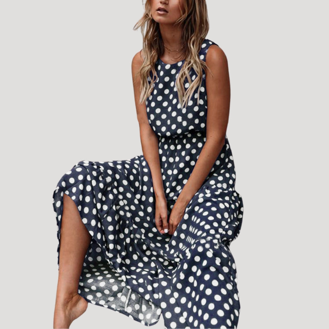 Casual women's sleeveless polka dot A-line midi dress, great for a comfortable and stylish summer day.