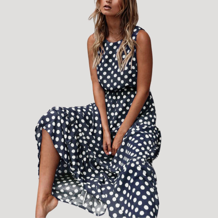 Casual women's sleeveless polka dot A-line midi dress, great for a comfortable and stylish summer day.
