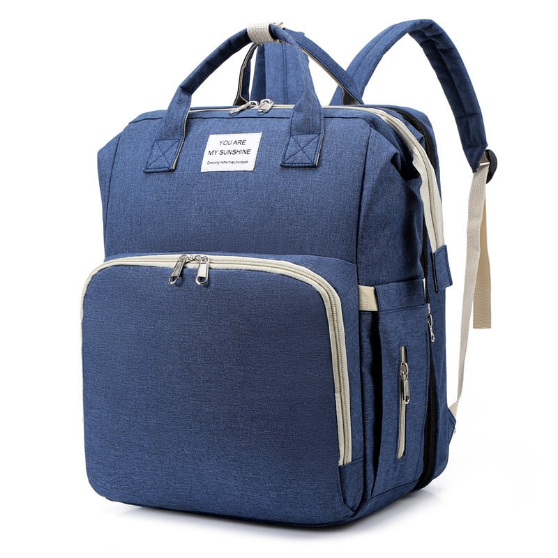 Convenient multi-function baby backpack with changing station & portable bed for outings.