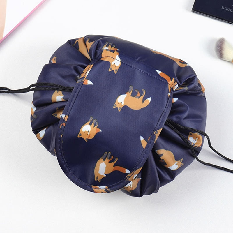 Women's portable drawstring cosmetic bag, shown packed with travel essentials. Grey flamingo print.
