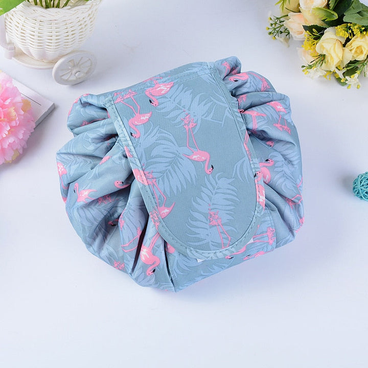 Versatile portable makeup organizer bag. Waterproof grey flamingo drawstring design for travel.