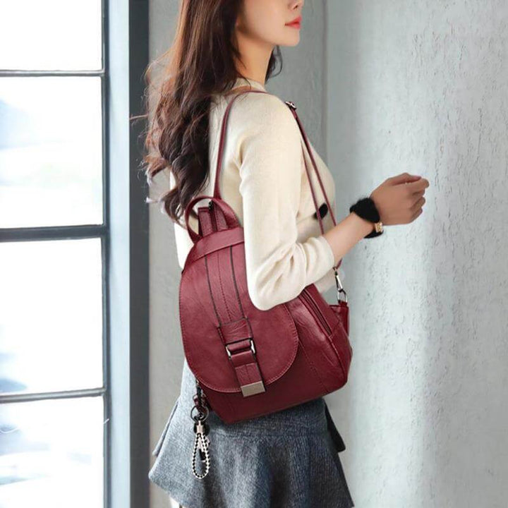 Women's water-resistant leather backpack with multiple compartments, designed for organization.