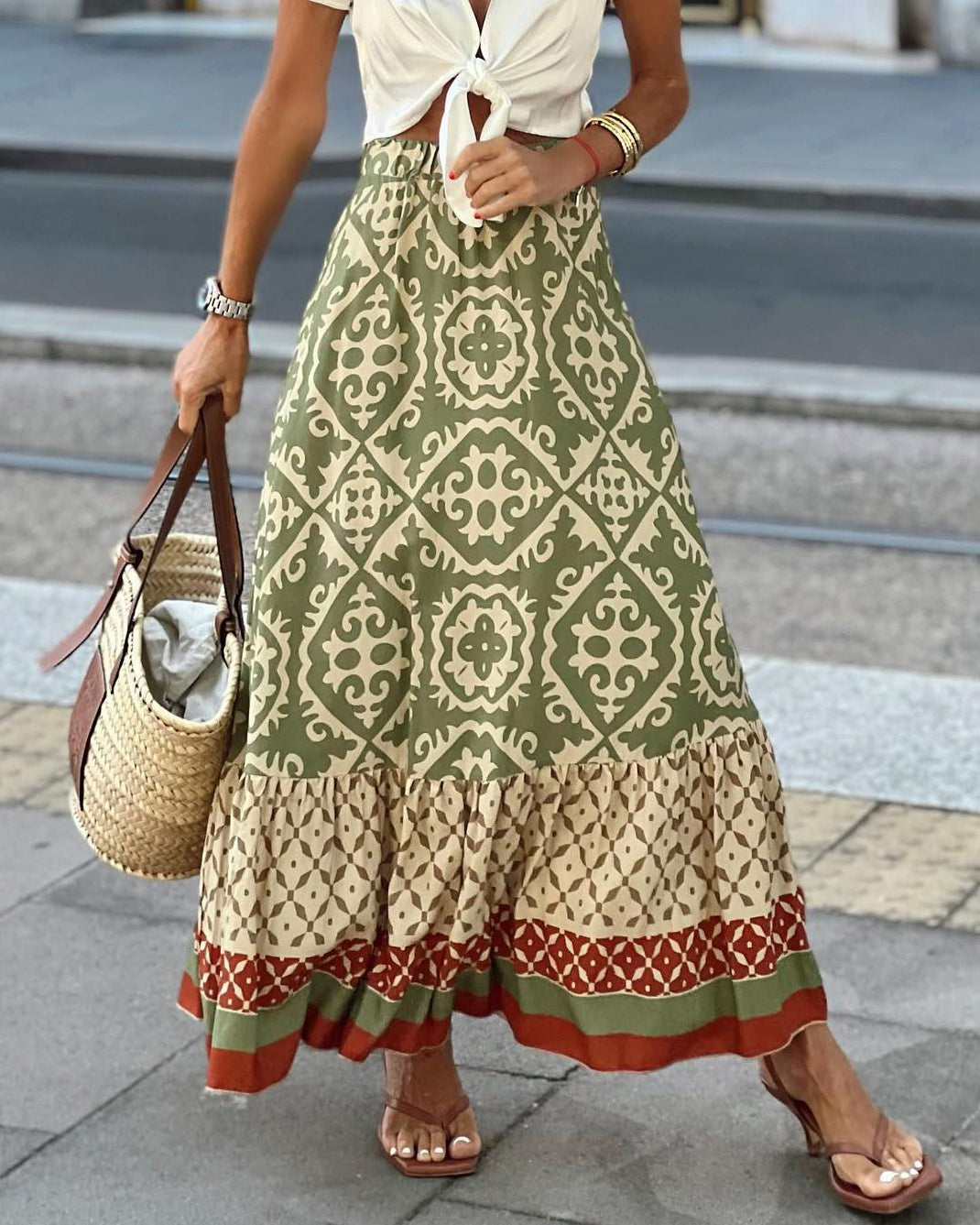 Women's printed boho maxi skirt with flowing fringes, perfect for summer festivals.