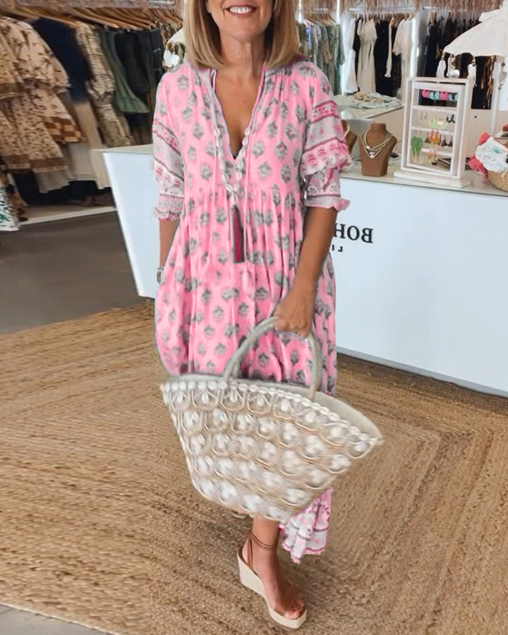 Chic women's printed midi dress. Bohemian elegance with a V-neck, lantern sleeves, and practical pockets.