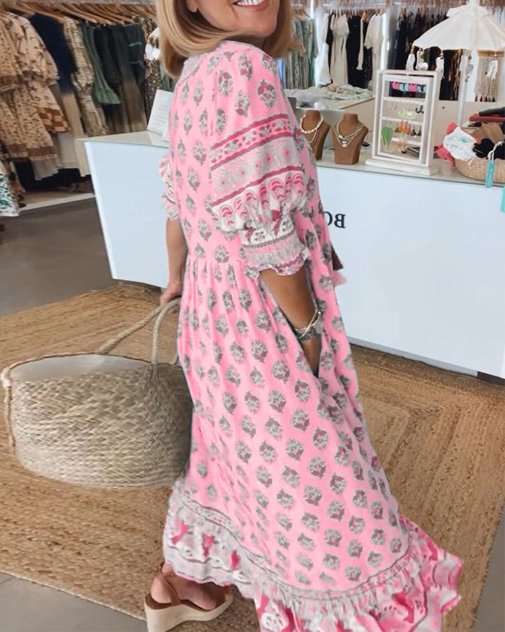 Casual yet elegant women's midi dress with eye-catching print, V-neck, lantern sleeves, and pockets.