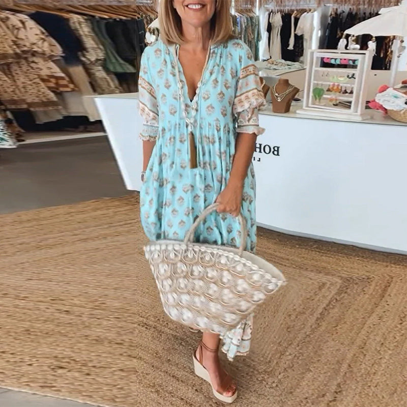 Comfortable women's printed midi dress with bohemian flair. V-neck, lantern sleeves, and practical pockets.