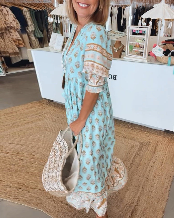 V-neck lantern sleeve midi dress with vibrant print and pockets. Ideal for bohemian women's fashion.