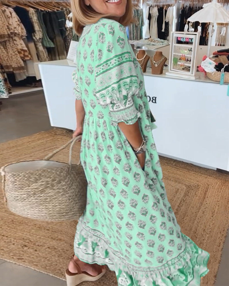Elegant women's midi dress featuring lantern sleeves, stylish print, V-neck, and practical pockets.