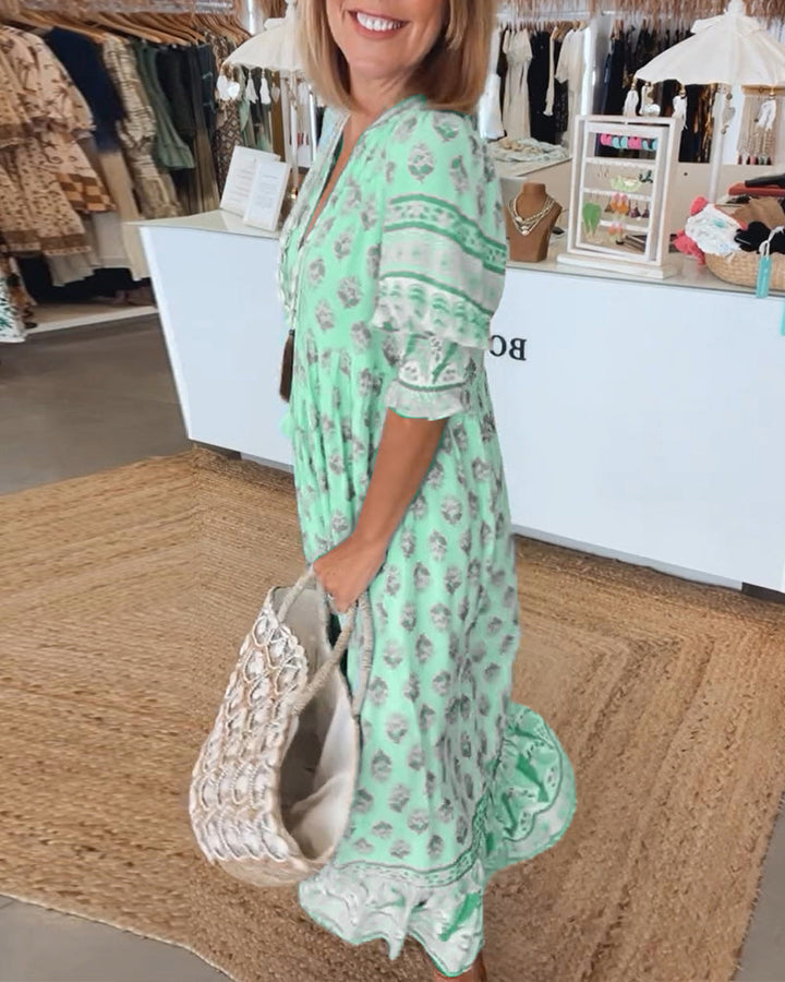 Summer-ready bohemian printed midi dress for women. Comfortable, chic V-neck design with pockets.