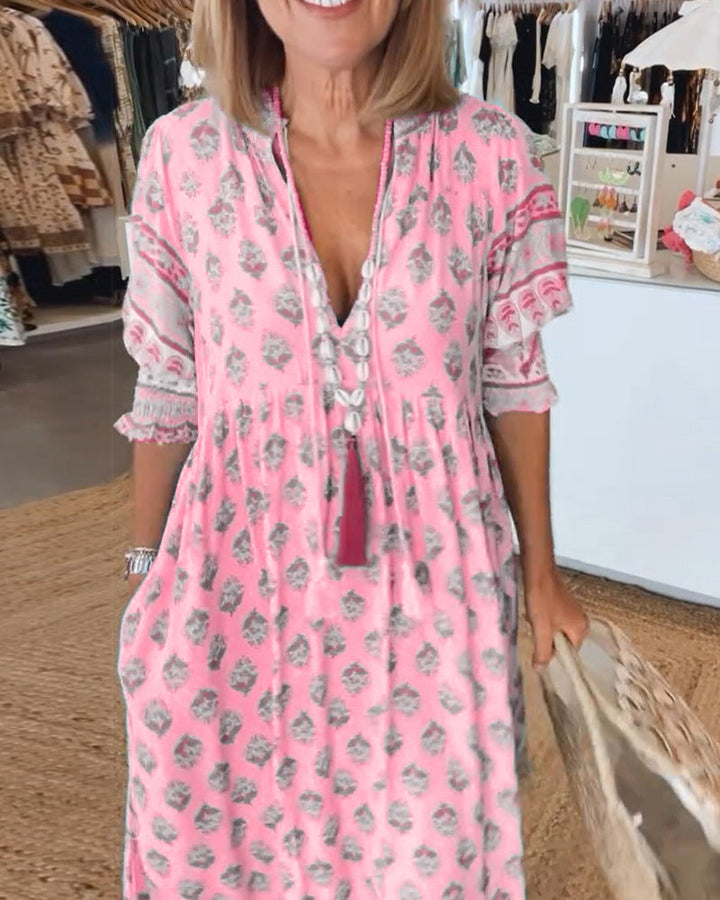 Soft, flowy printed midi dress for women. Effortless bohemian style with V-neck, lantern sleeves, and pockets.