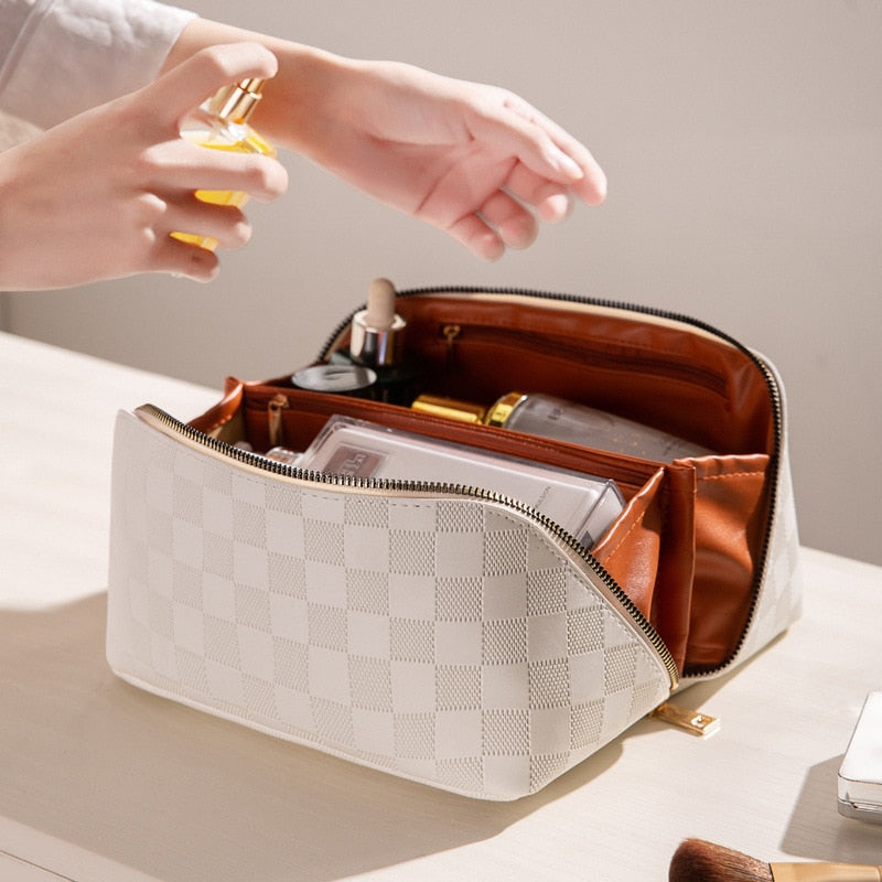 Women's PU leather travel cosmetic bag organizer with multiple compartments, a portable makeup storage solution