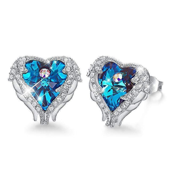Close-up of women's crystal angel wing heart earrings, with purple & blue accents. Ideal spiritual gift.