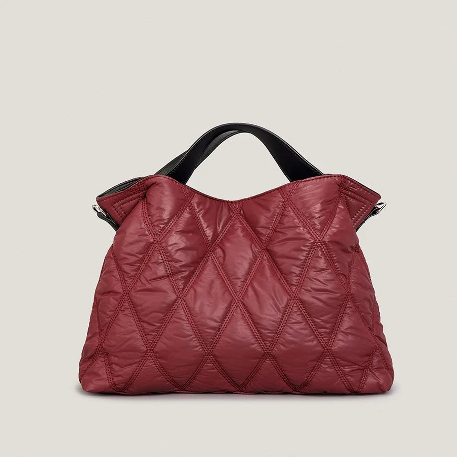 Close-up of a women's quilted tote bag, highlighting the soft texture and durable cotton down material.