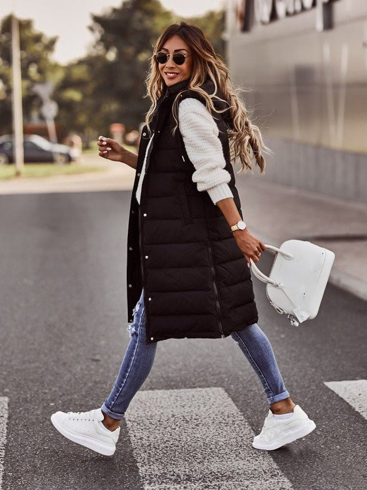 Comfortable women's quilted sleeveless coat, knee-length for extra winter warmth and casual wear.