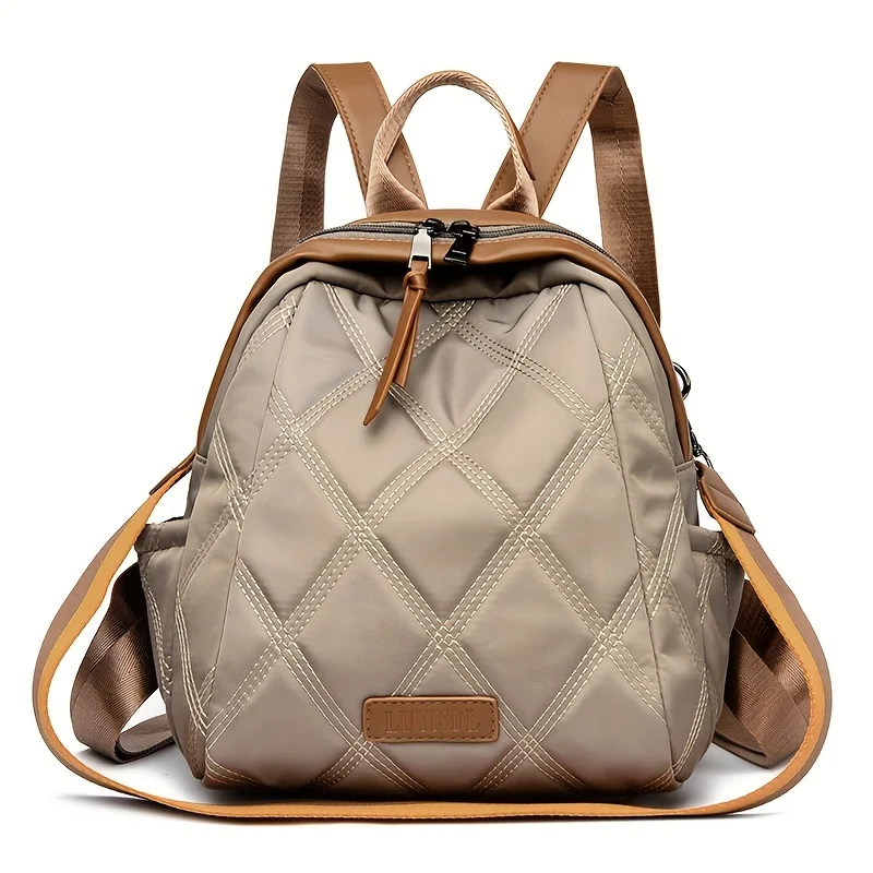 Stylish women's quilted nylon convertible backpack, practical for travel, shoulder, and crossbody use.
