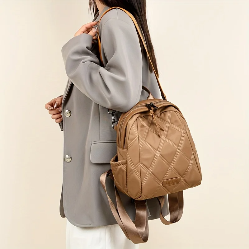 Versatile women's quilted backpack, converts to shoulder or crossbody bag. Perfect travel bag.