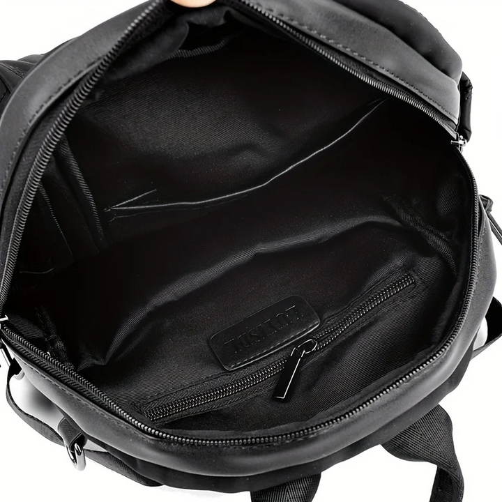 Back view: Women's quilted convertible backpack with adjustable straps. Transforms to shoulder or crossbody.